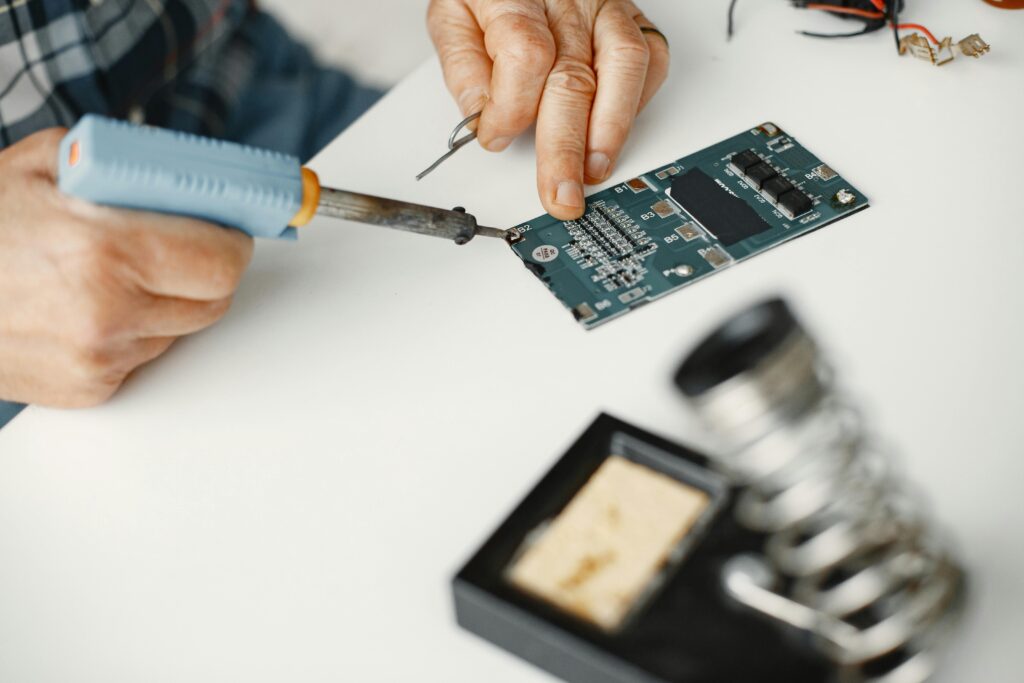 Detailed view of soldering work on a circuit board, highlighting precision in electronics repair.