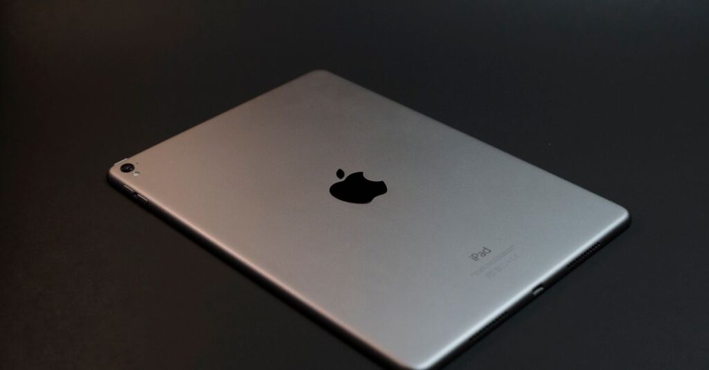 A modern silver tablet with a sleek design on a dark surface, showcasing advanced technology.