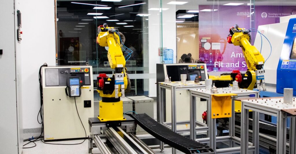 Robotic arms in action within a modern industrial control room setting, showcasing technology and production.