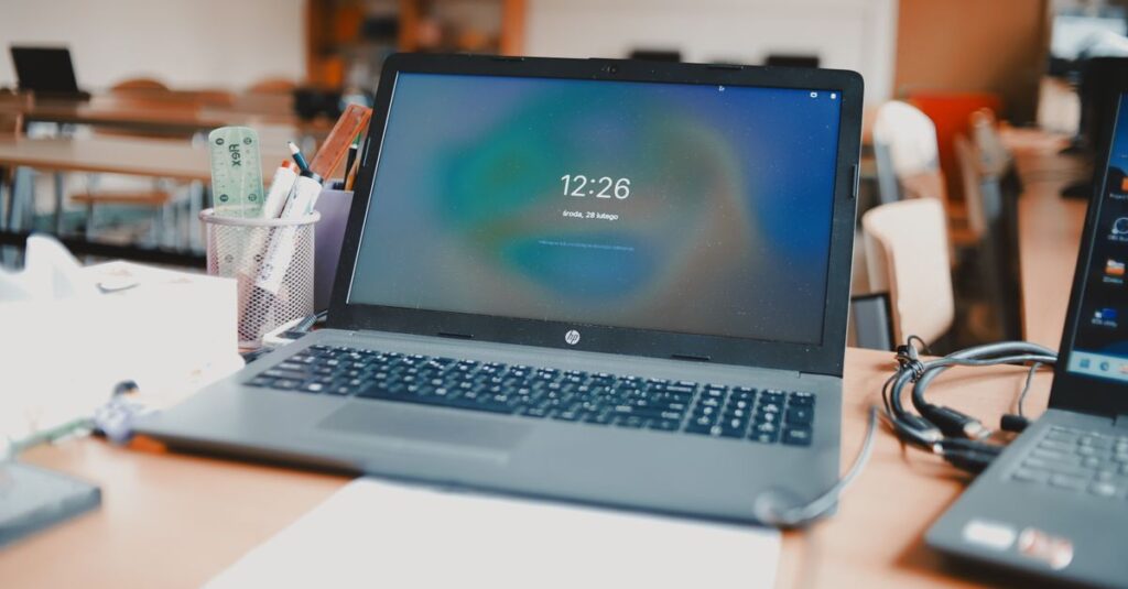 A classroom setting featuring laptops and desks, capturing a modern educational environment.