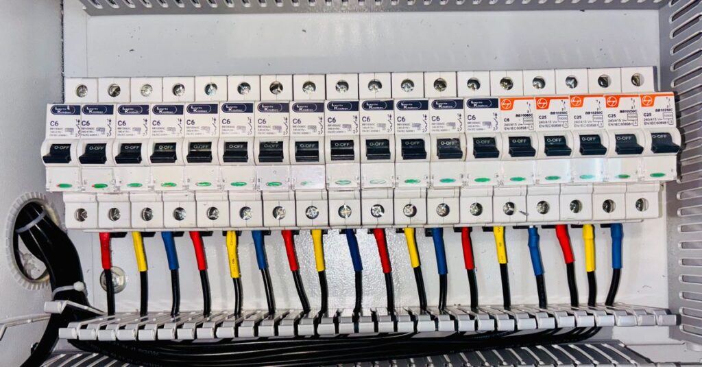 Close-up of an organized circuit breaker panel featuring color-coded electrical wiring.