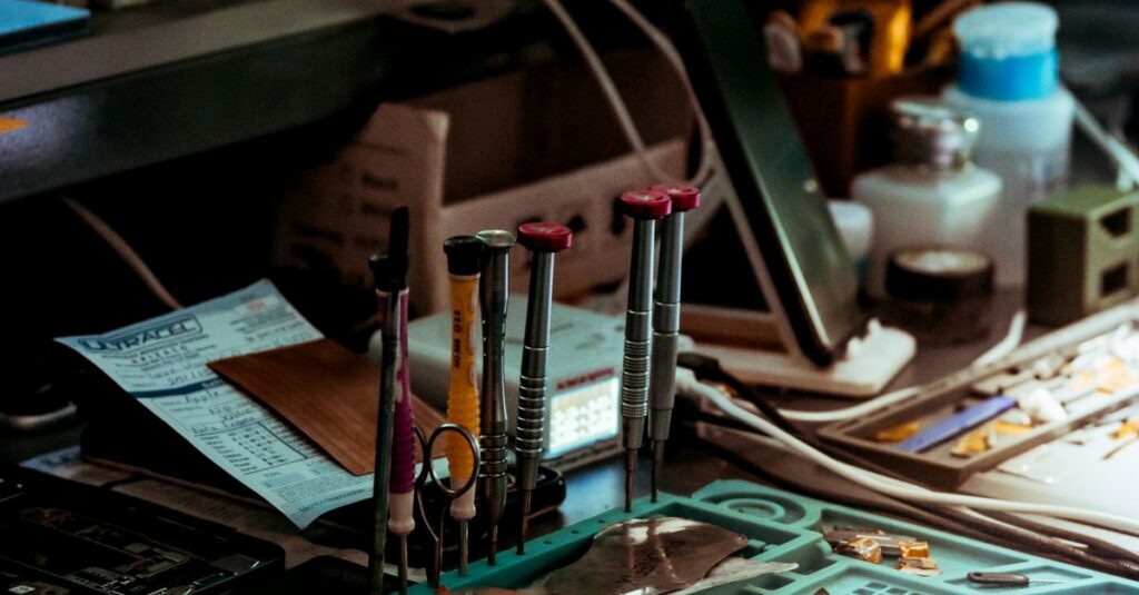 Detailed view of a tech repair workspace with tools and electronics parts.