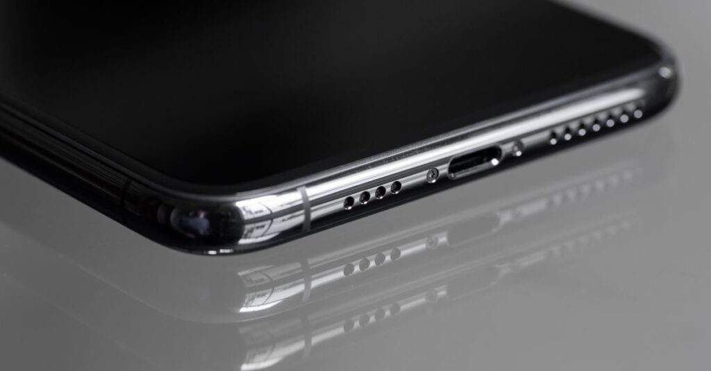 Detailed close-up of a smartphone's edge with a reflective surface, emphasizing sleek design.