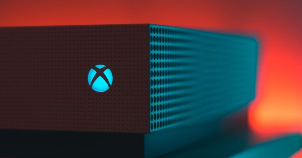 Close-up of an illuminated gaming console with a red and blue light aura.
