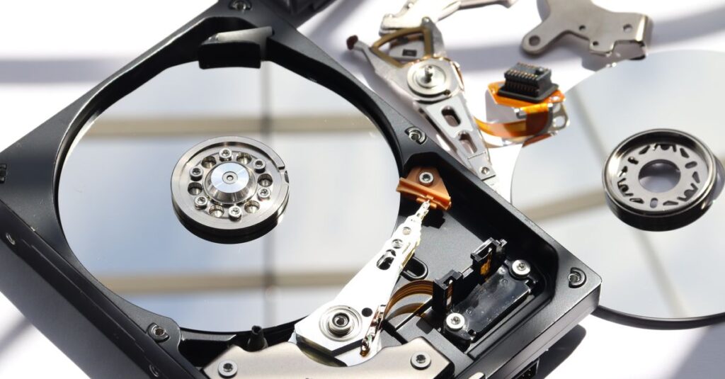 Detailed view of disassembled HDD showing intricate internal components.