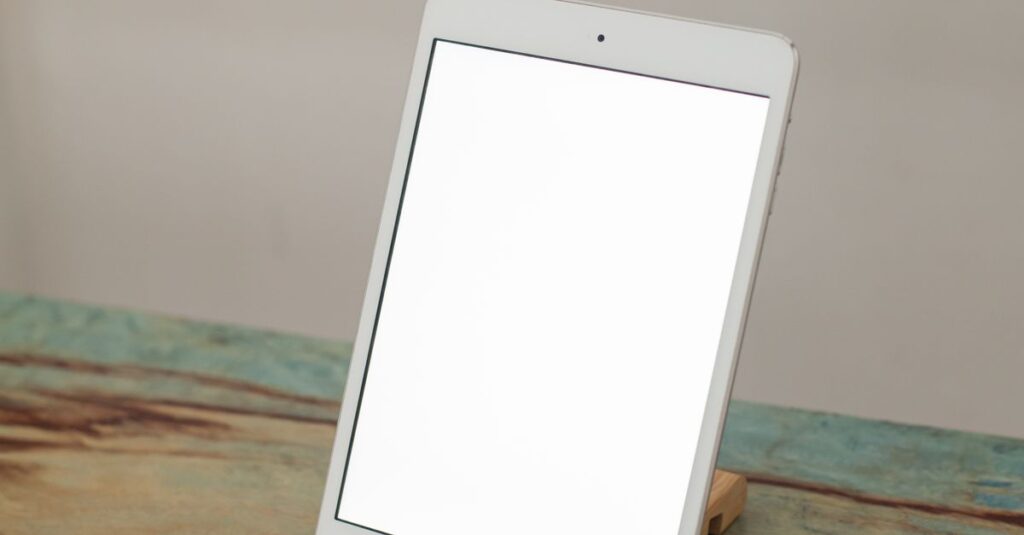 A tablet with a blank screen on a wooden stand, ideal for mockups.