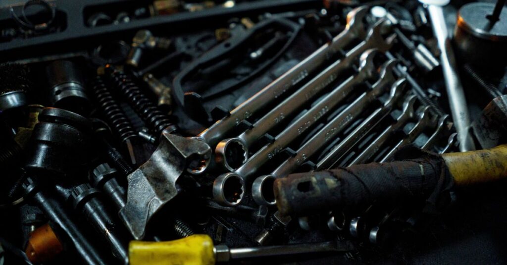 Detailed view of various mechanical tools laid out in a toolbox, ideal for industrial themes.